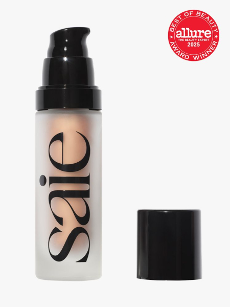 Saie Glowy Super Gel cloudy bottle of champagne gel primer with black pump and cap on light gray background with red Allure Best of Beauty seal in the top right corner